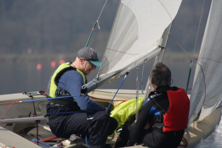 The crew of a GP14 heel the boat in light winds