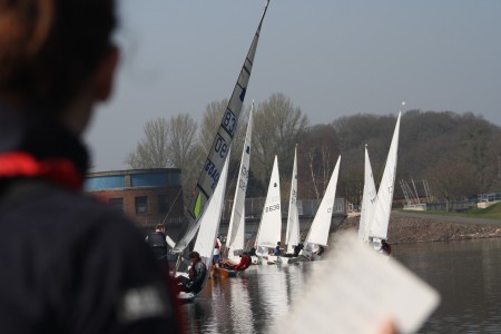 A fleet of GP14s in a race training session