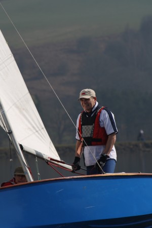 A man sails a GP14 heeled over in very light winds